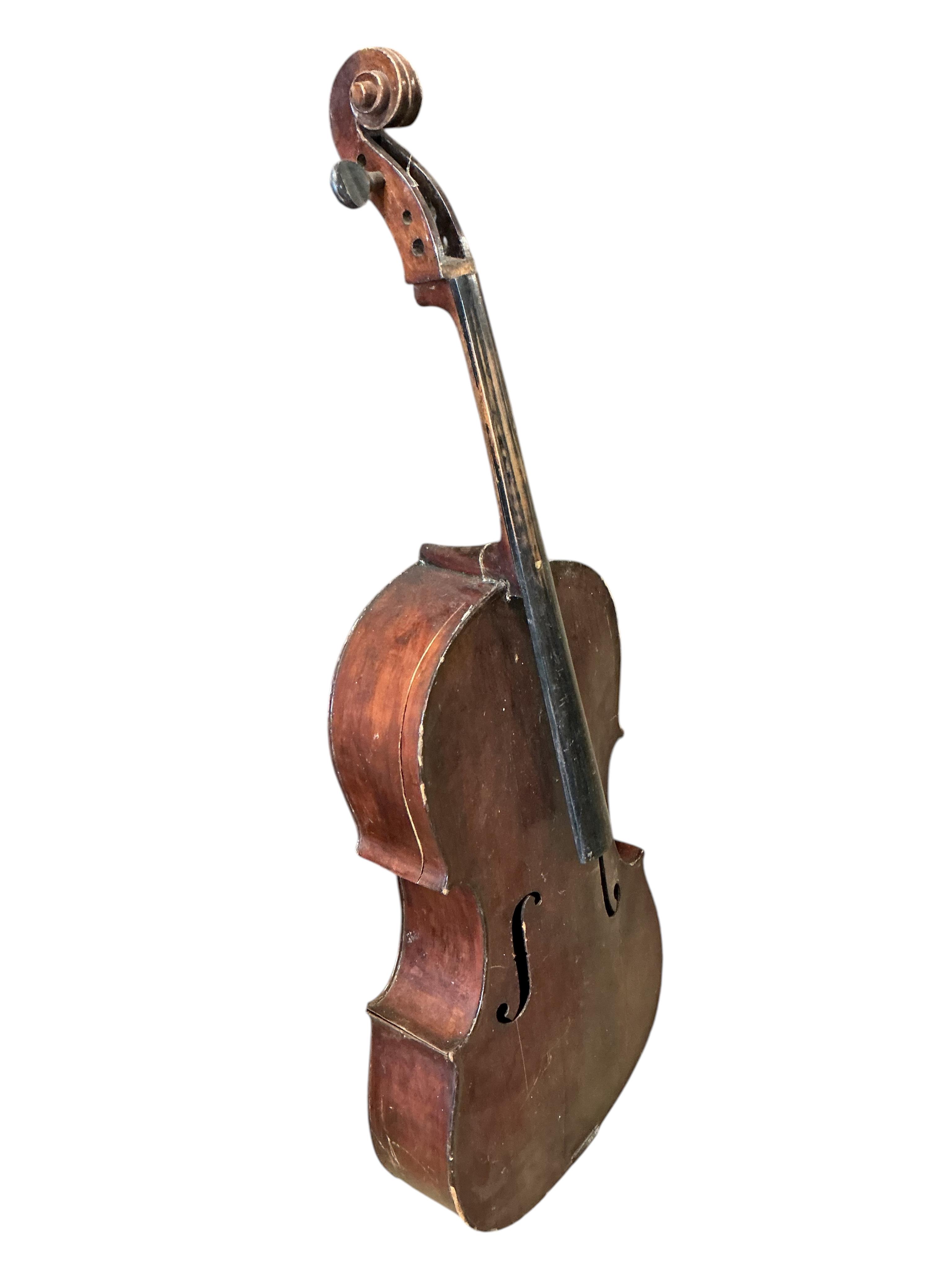 A small cello and assorted instruments in need of restoration